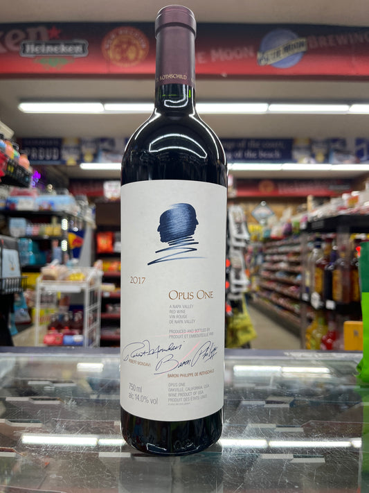A bottle of Opus One wine with a label that includes the brand name and '2017' vintage.