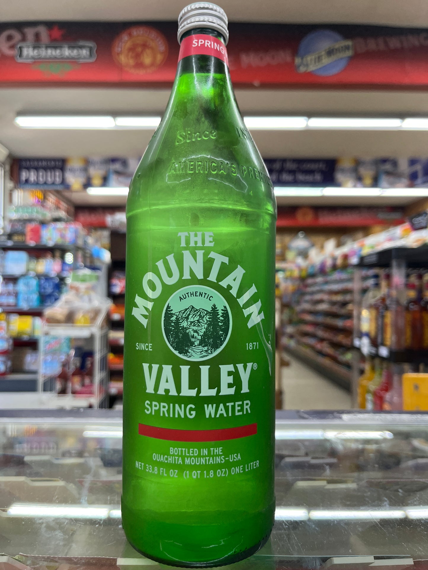 Green bottle of Mountain Valley Spring Water in a store setting