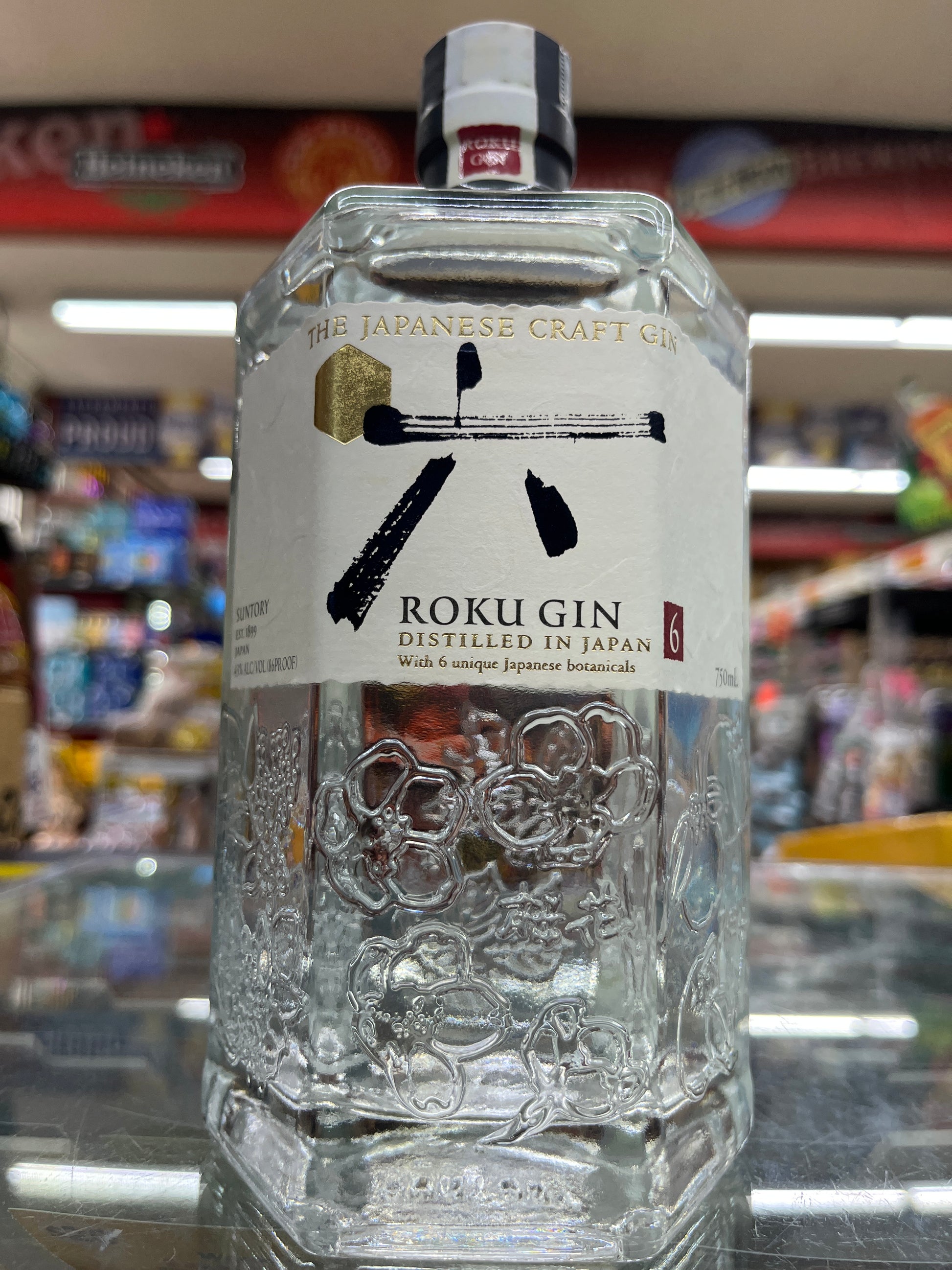 Bottle of Roku Japanese Gin 750 ml Bottle with a blurred bar background