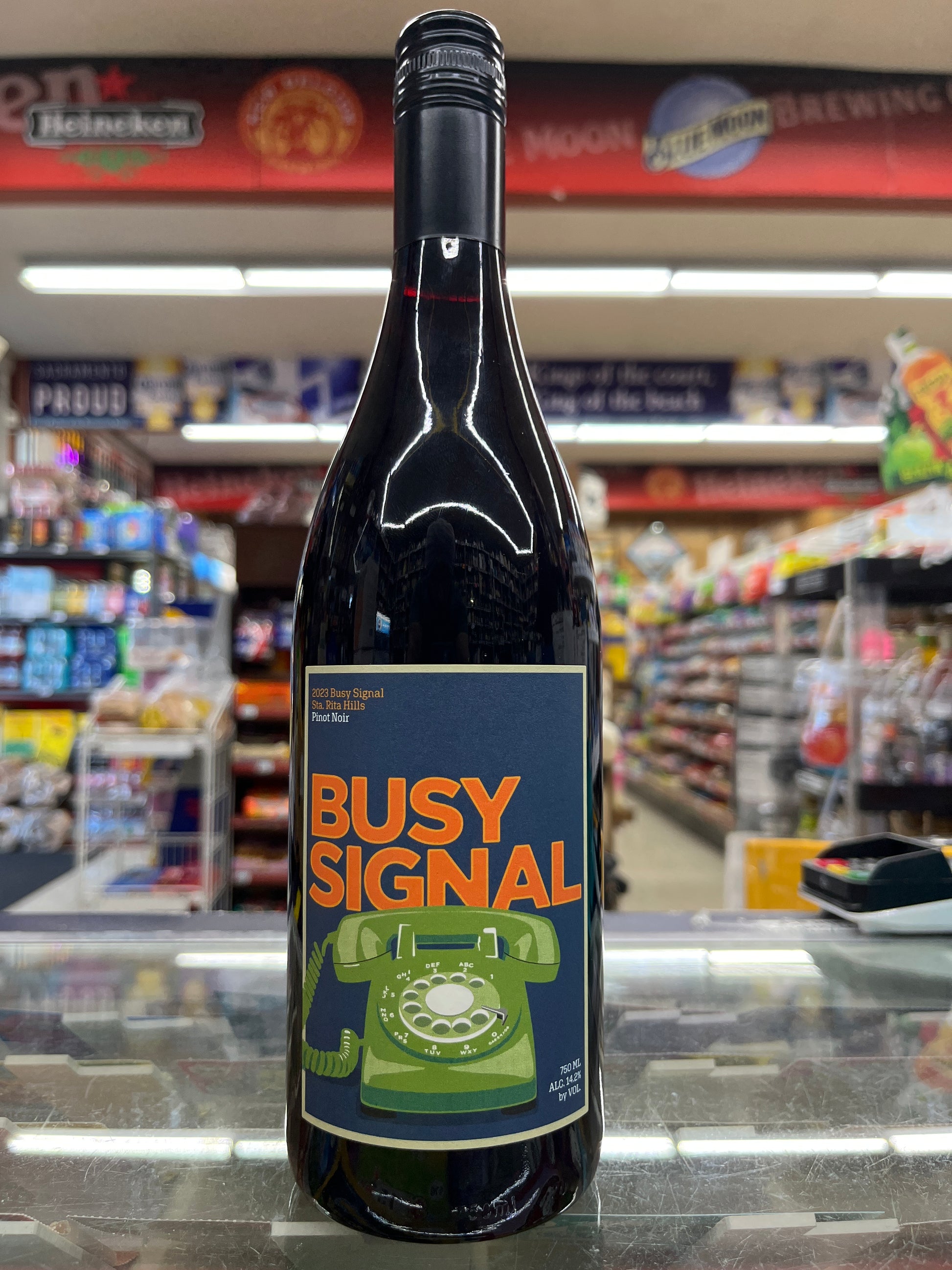 Bottle of Busy Signal Pinot Noir with a label featuring a phone design.