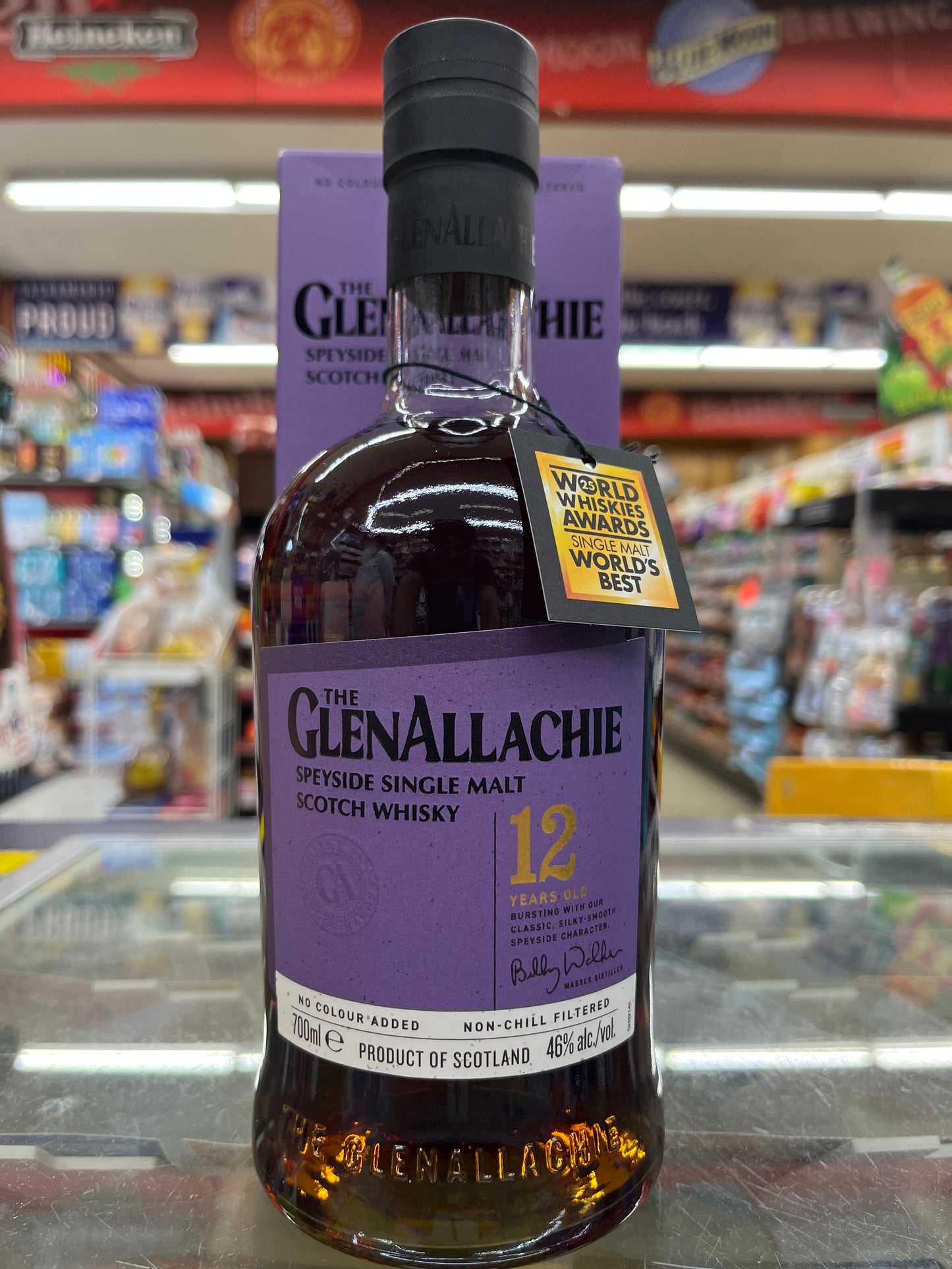 Bottle of Glenallachie whisky 12years old with a purple label in a store setting