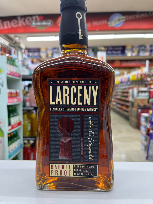 Bottle of Larceny Barrel Proof Kentucky Straight Bourbon whiskey with a blurred store shelf in the background