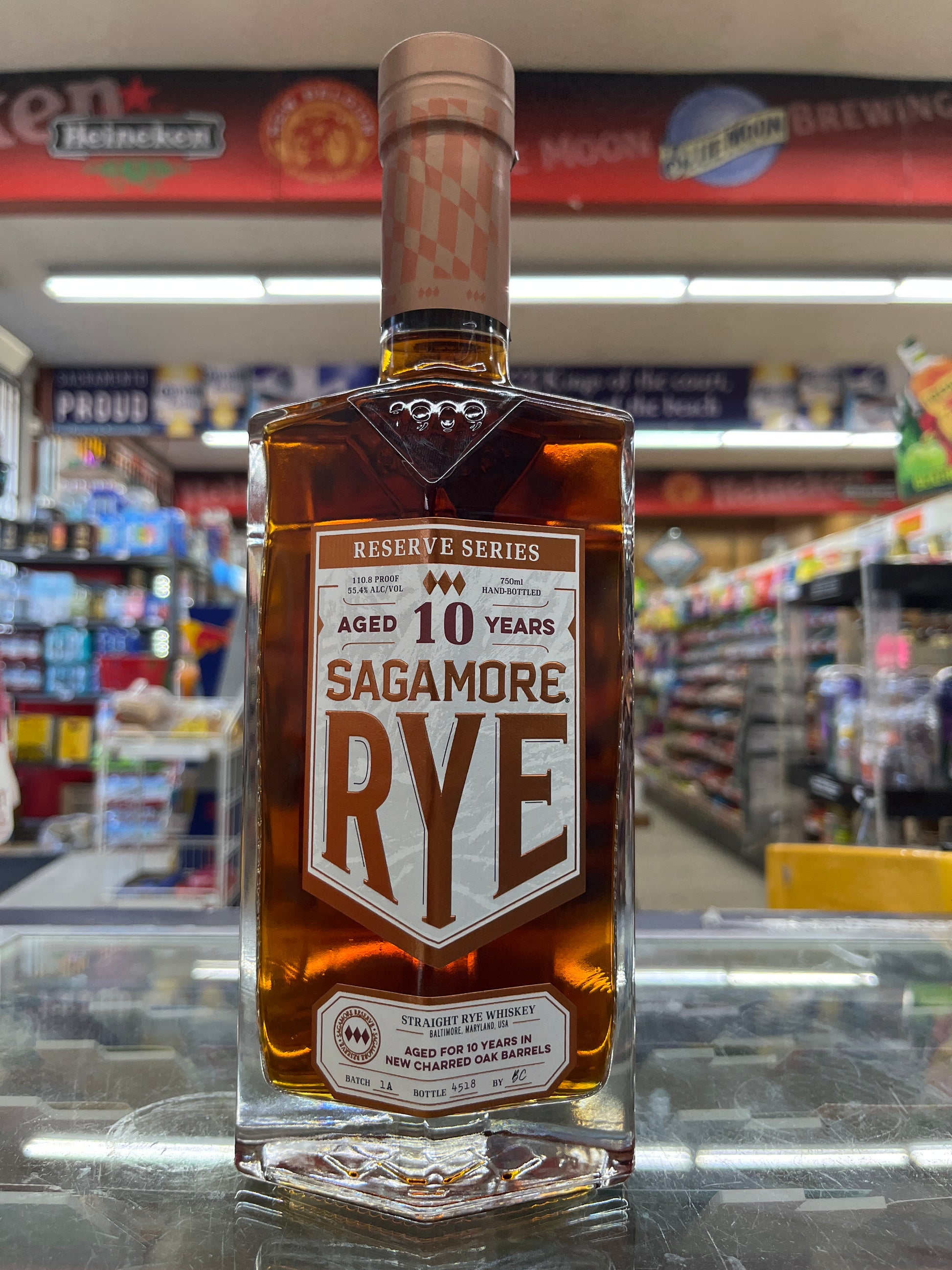 Bottle of Sagamore Reserve Series 10 Year Old Rye Whiskey with a blurred store shelf background