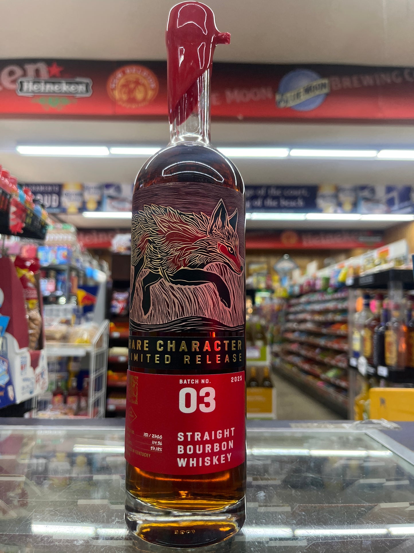 Bottle of Rare Character whiskey with a detailed label in a store setting