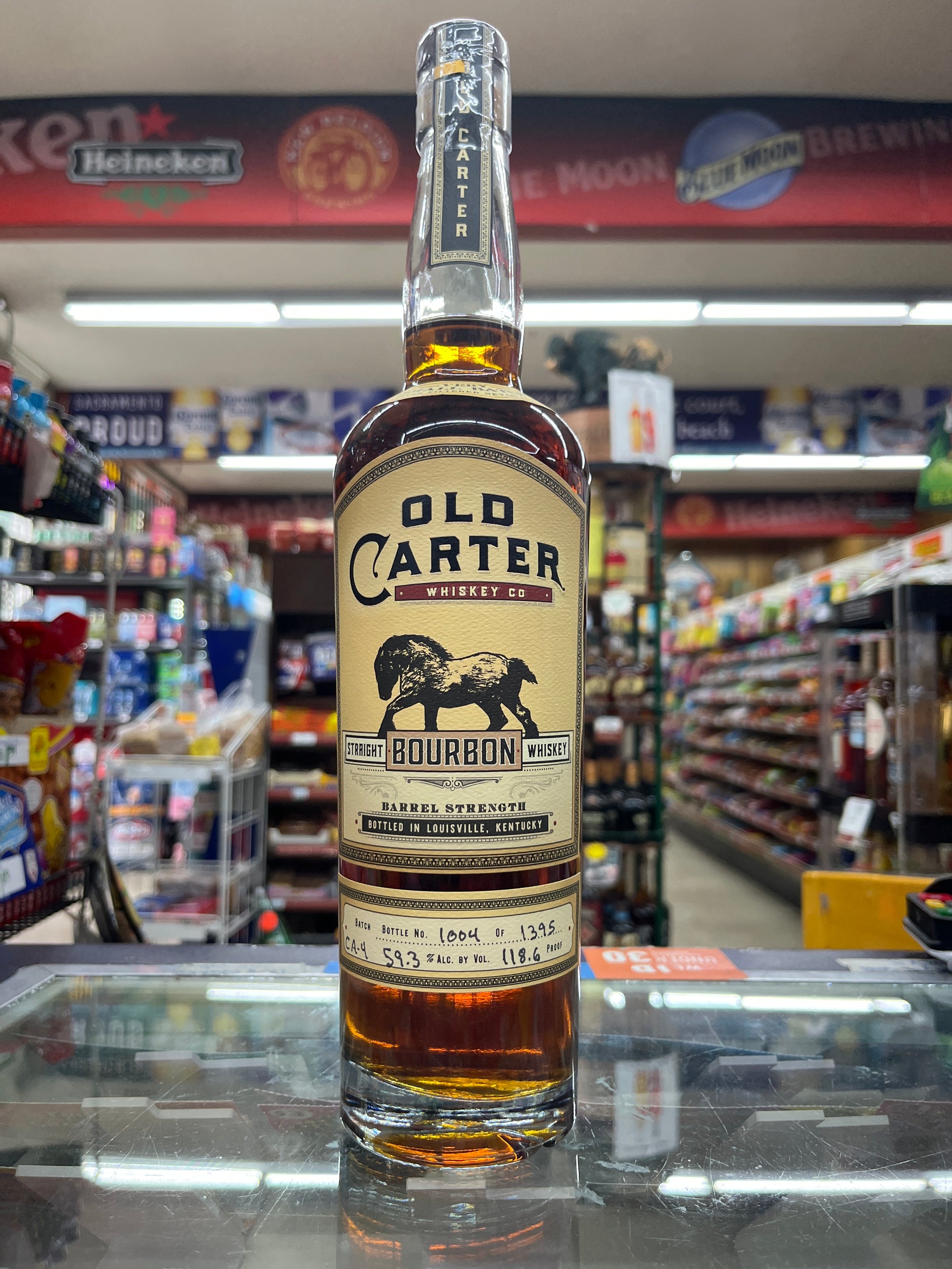 Bottle of Old Carter Straight Bourbon Whiskey Barrel Strength in a store setting