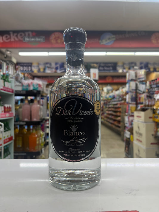 A bottle of Dan Vicente Blanco 100% Pure Tequila on a white counter inside a retail store.
