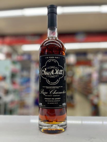 A bottle of Brook Hill 18 Years Old by Rare Character Whisey Company Straight Rye whiskey, standing on a white counter with a blurred store background.