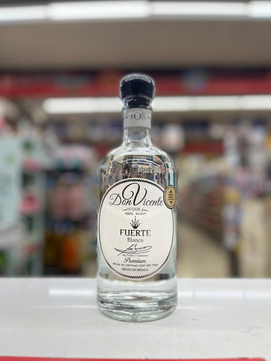 A bottle of Don Vicent Fuerte Blanco tequila standing on a white counter in a blurred retail store environment.