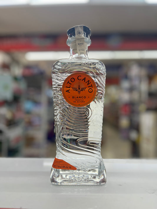 Alto Canto Tequila Blanco rested on a white counter with blurred background.